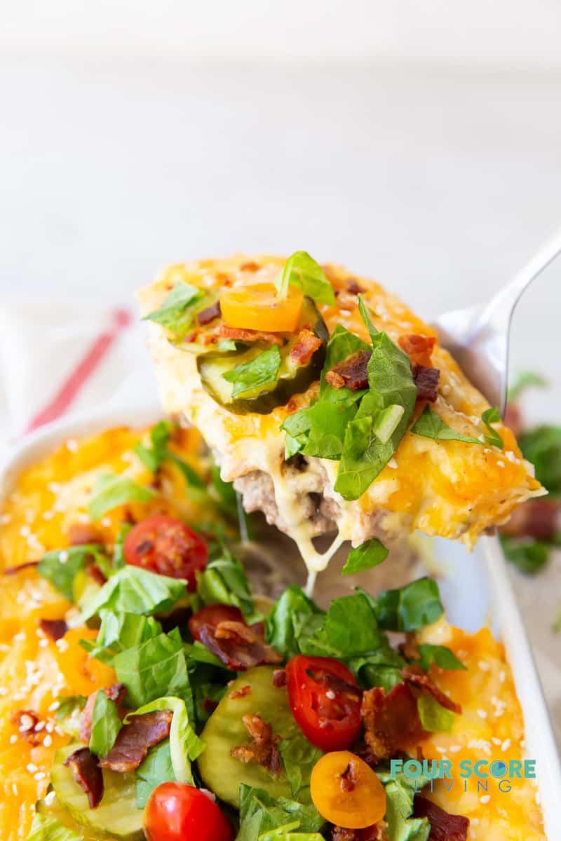 a casserole dish of keto cheeseburger casserole being served.