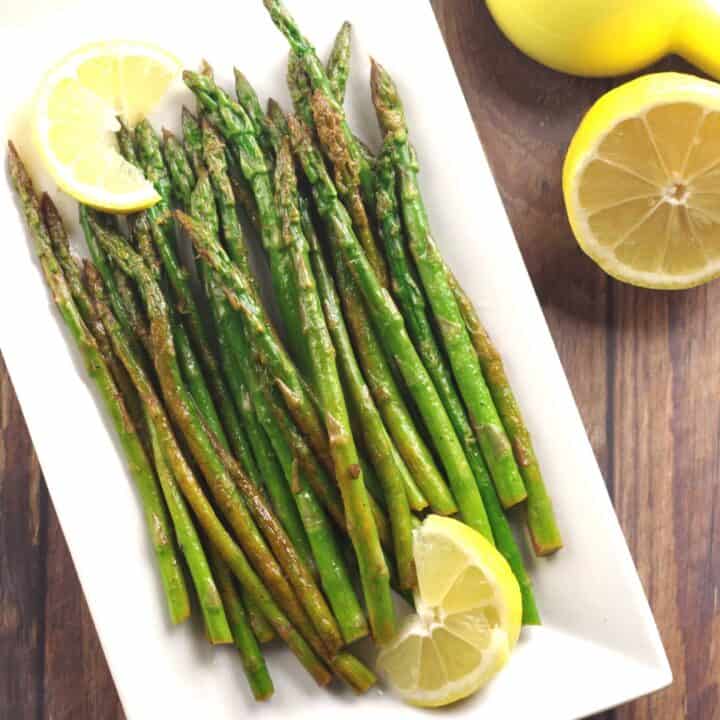 cooked asparagus on a white plate