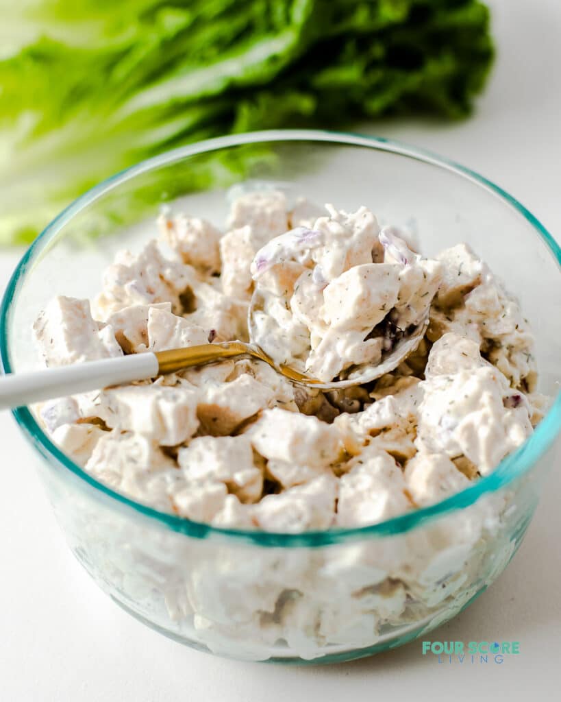 keto chicken salad in a clear bowl with a spoon