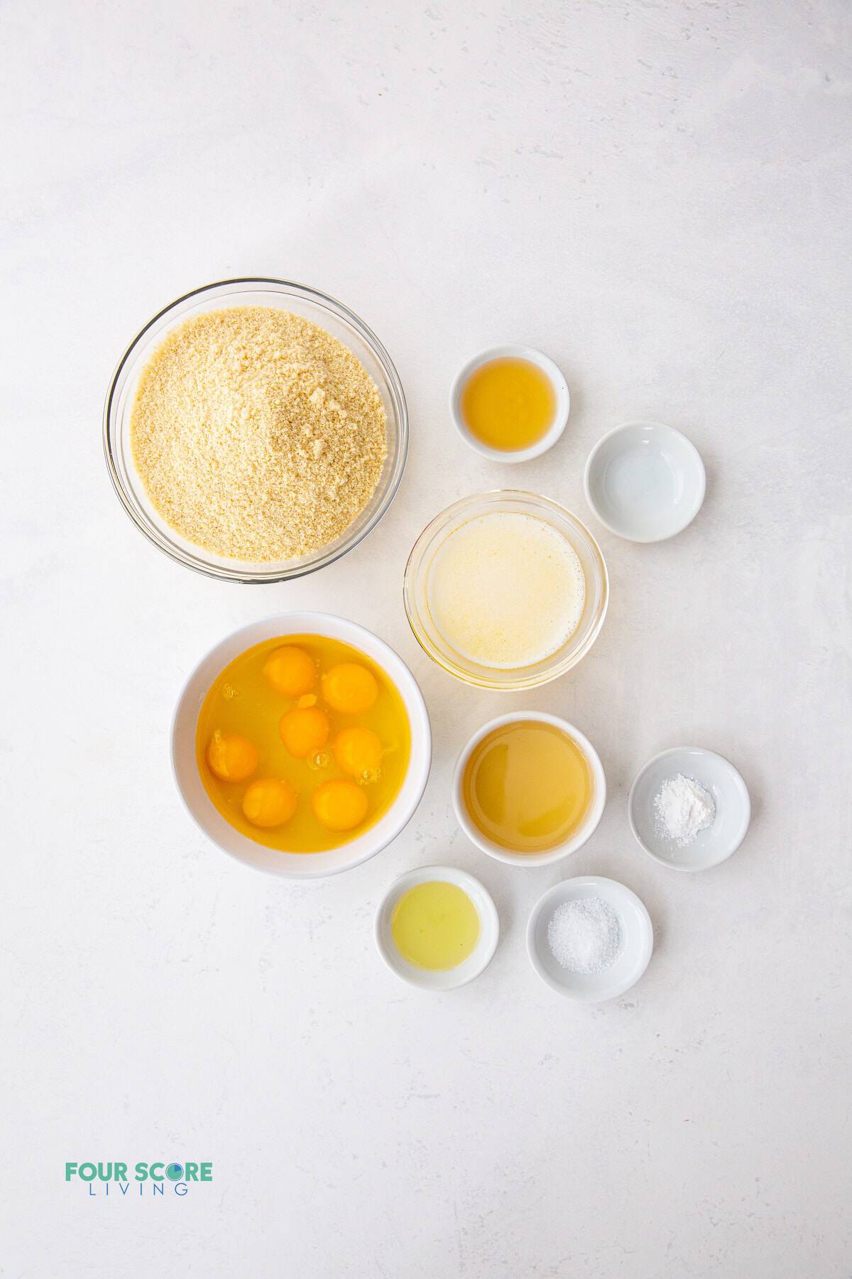 The ingredients for keto bread measured into smaller bowls and set on a counter, shot from above.