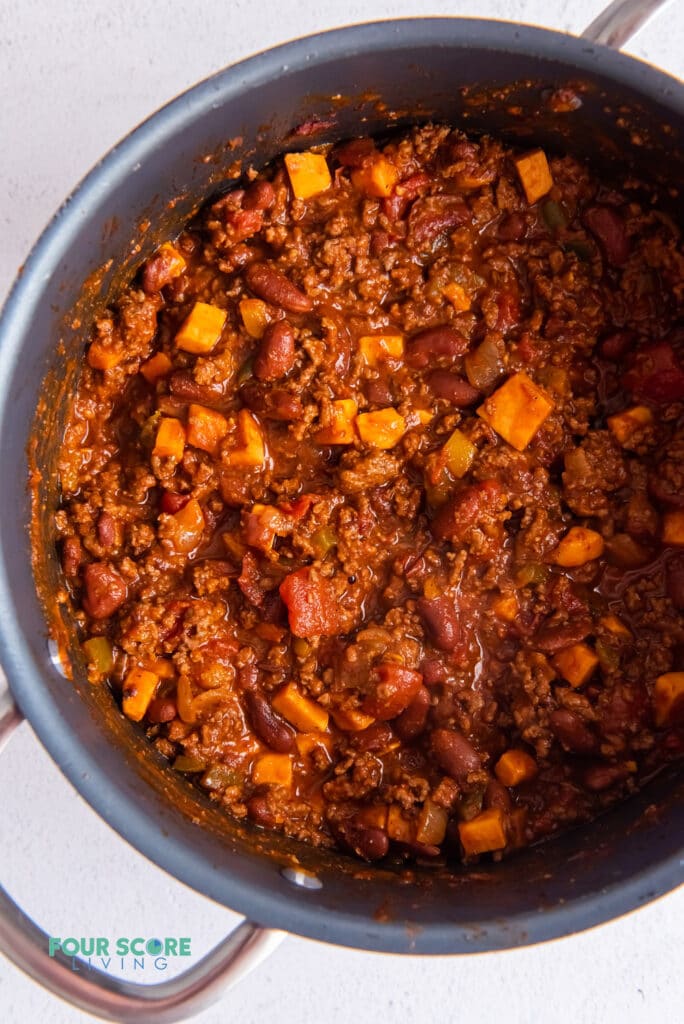 a large pot with handles filled with chili.