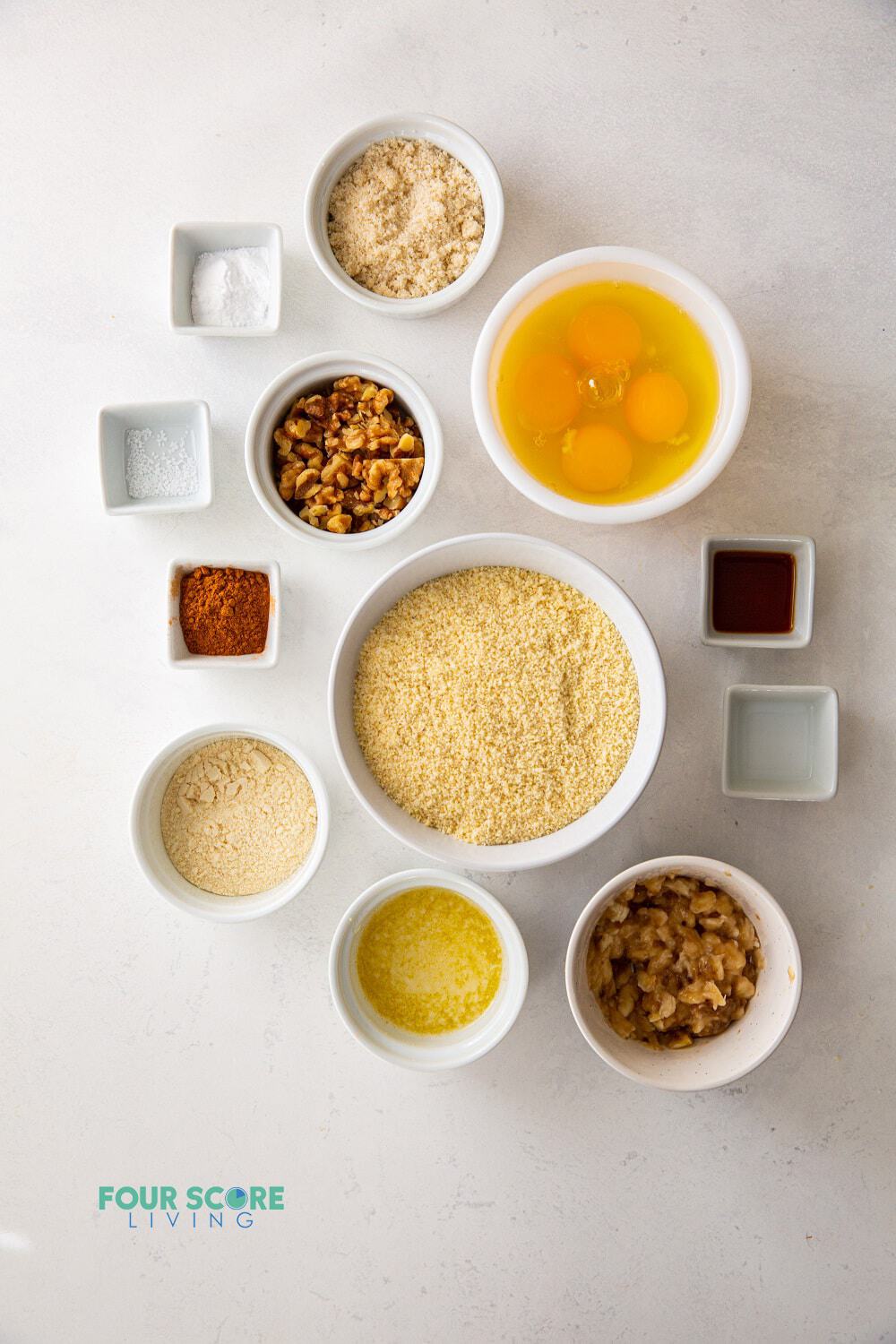 All of the ingredients needed to make Keto banana bread in separate bowls on a counter.