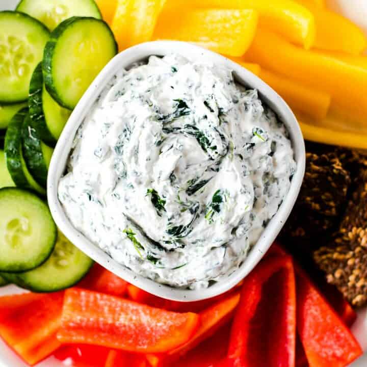 keto spinach dip in a white bowl with vegetables