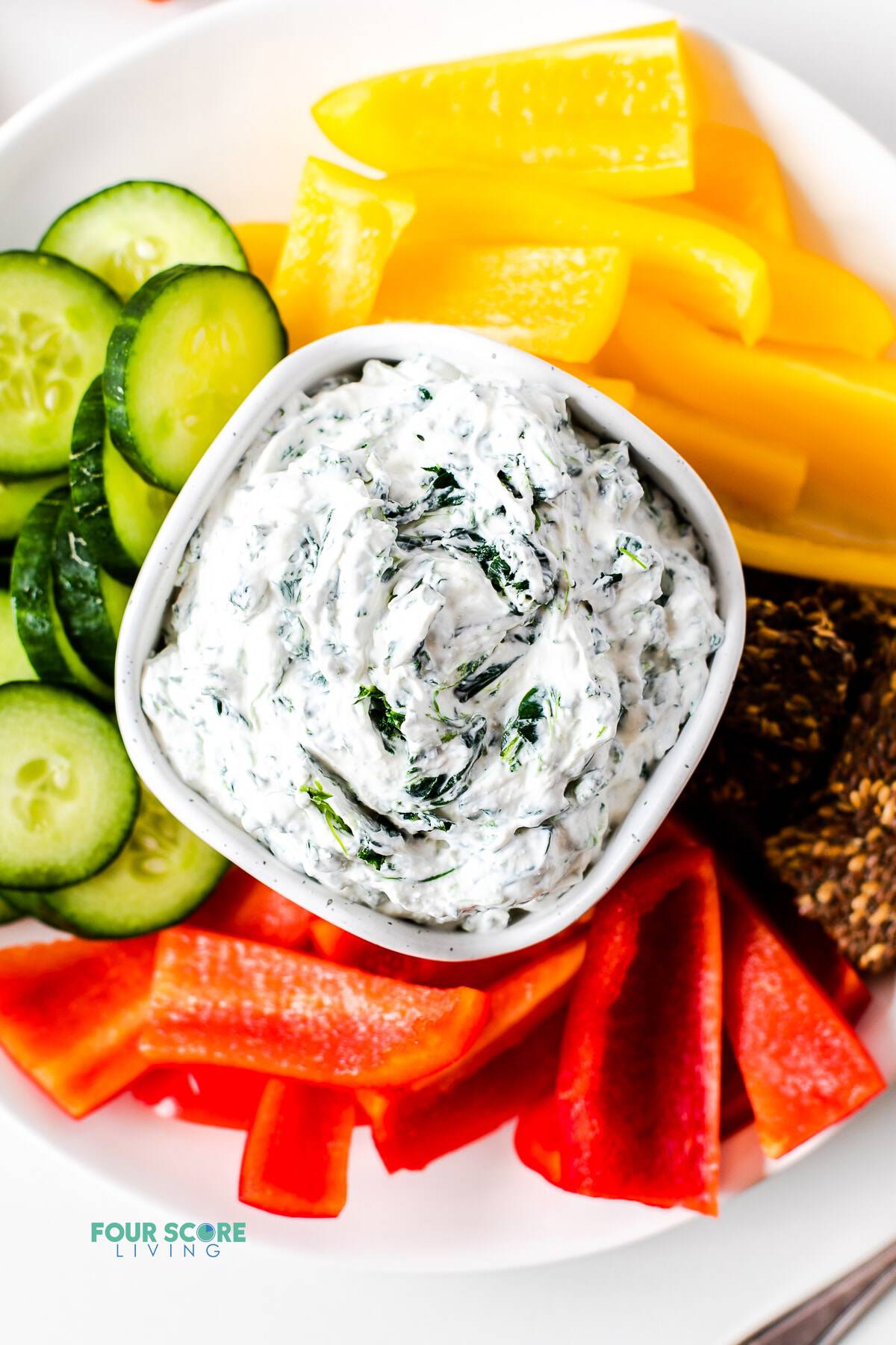 keto spinach dip in a white bowl with vegetables