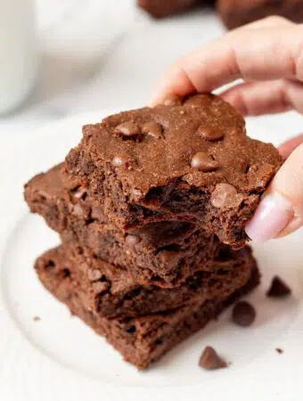 hand holding a keto brownie with a bite out