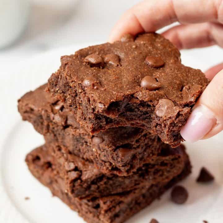 hand holding a keto brownie with a bite out