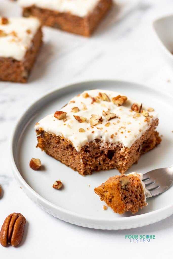keto carrot cake bar on a white plate with a bite out