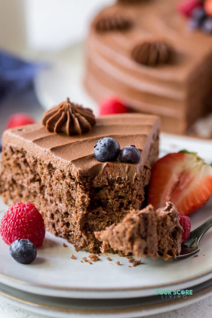 close up of a slice of almond flour chocolate cake with a bite out