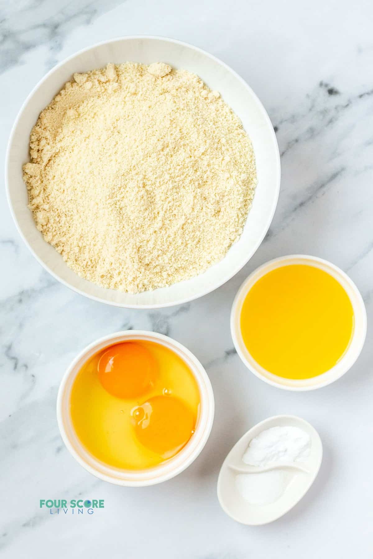 The ingredients needed for almond flour biscuits, including butter and eggs