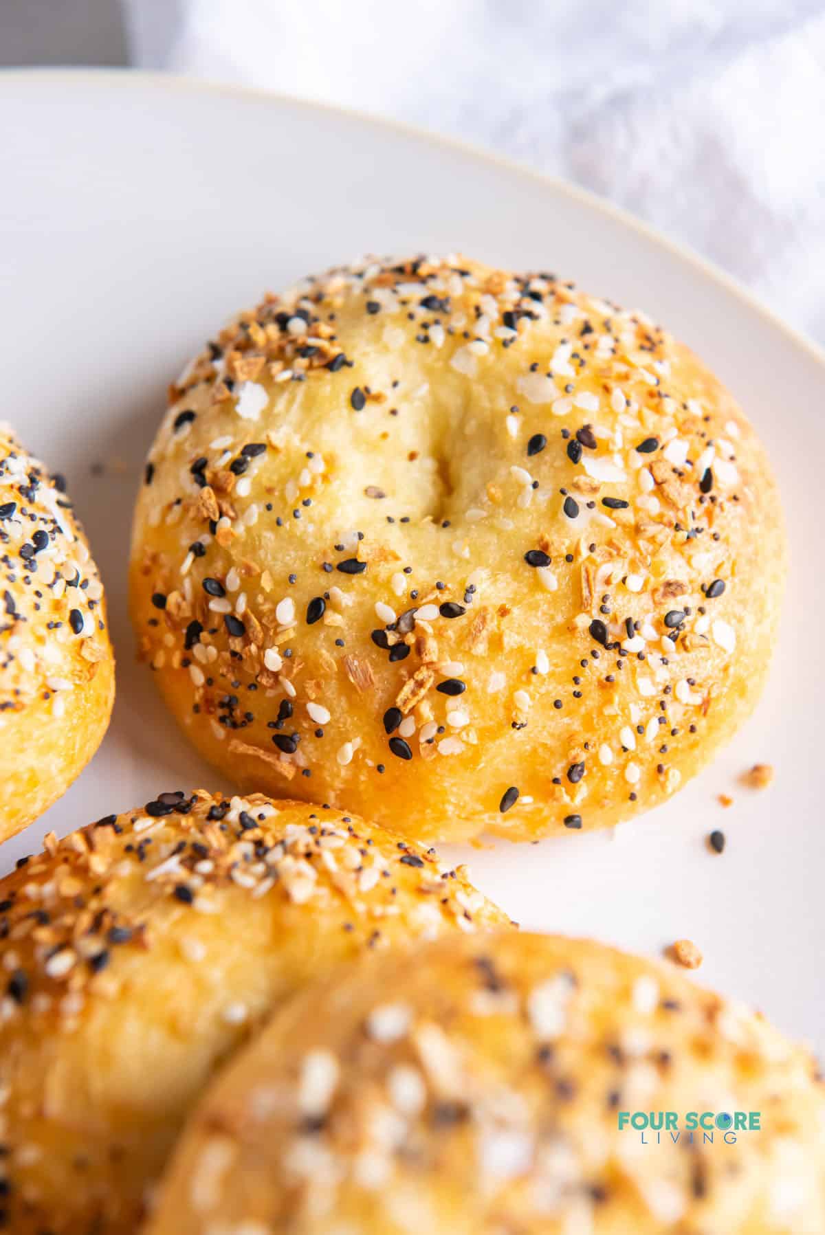 closeup shot of a keto bagel with sesame seeds and poppy seeds.