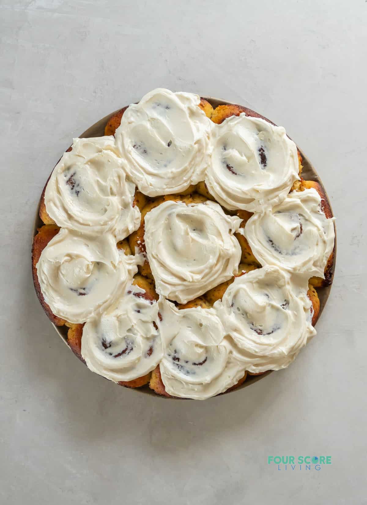 a round pan of keto cinnamon rolls with cream cheese frosting