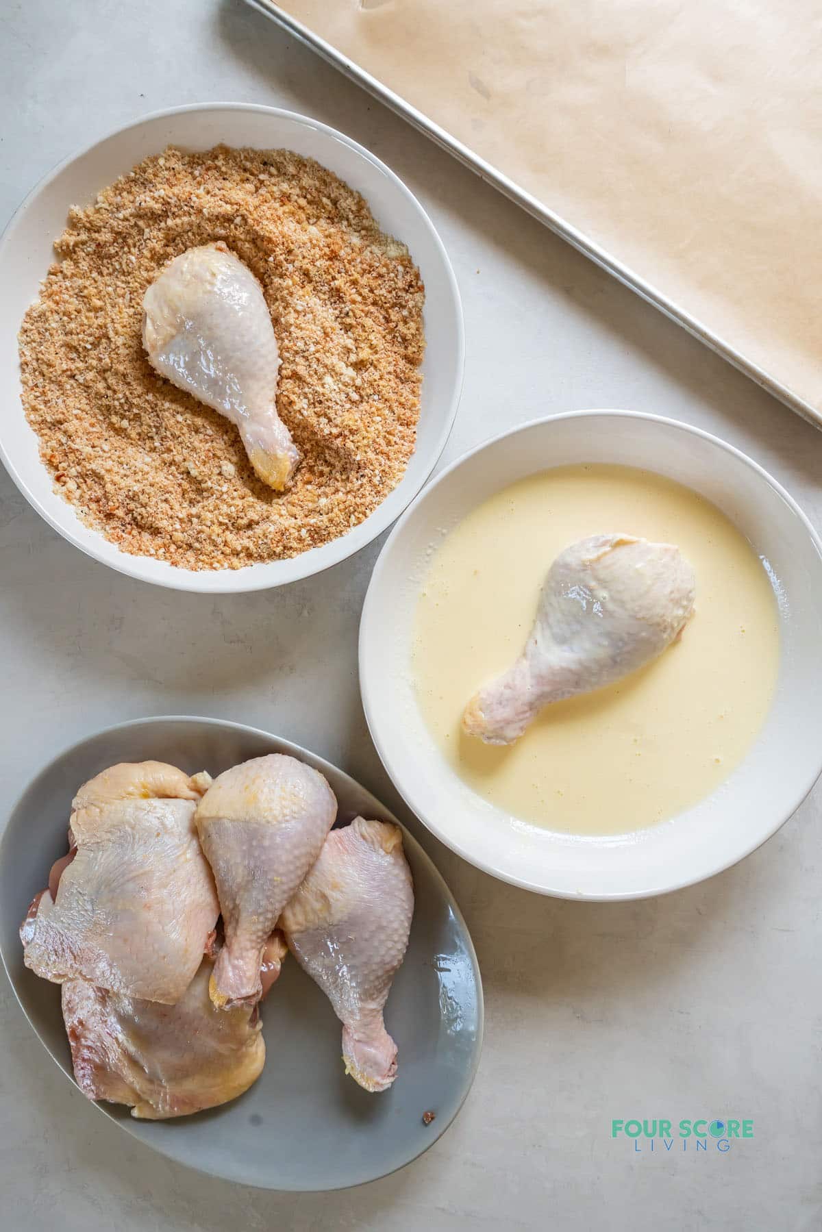 A three part breading station set up to show how to coat chicken pieces in keto breading