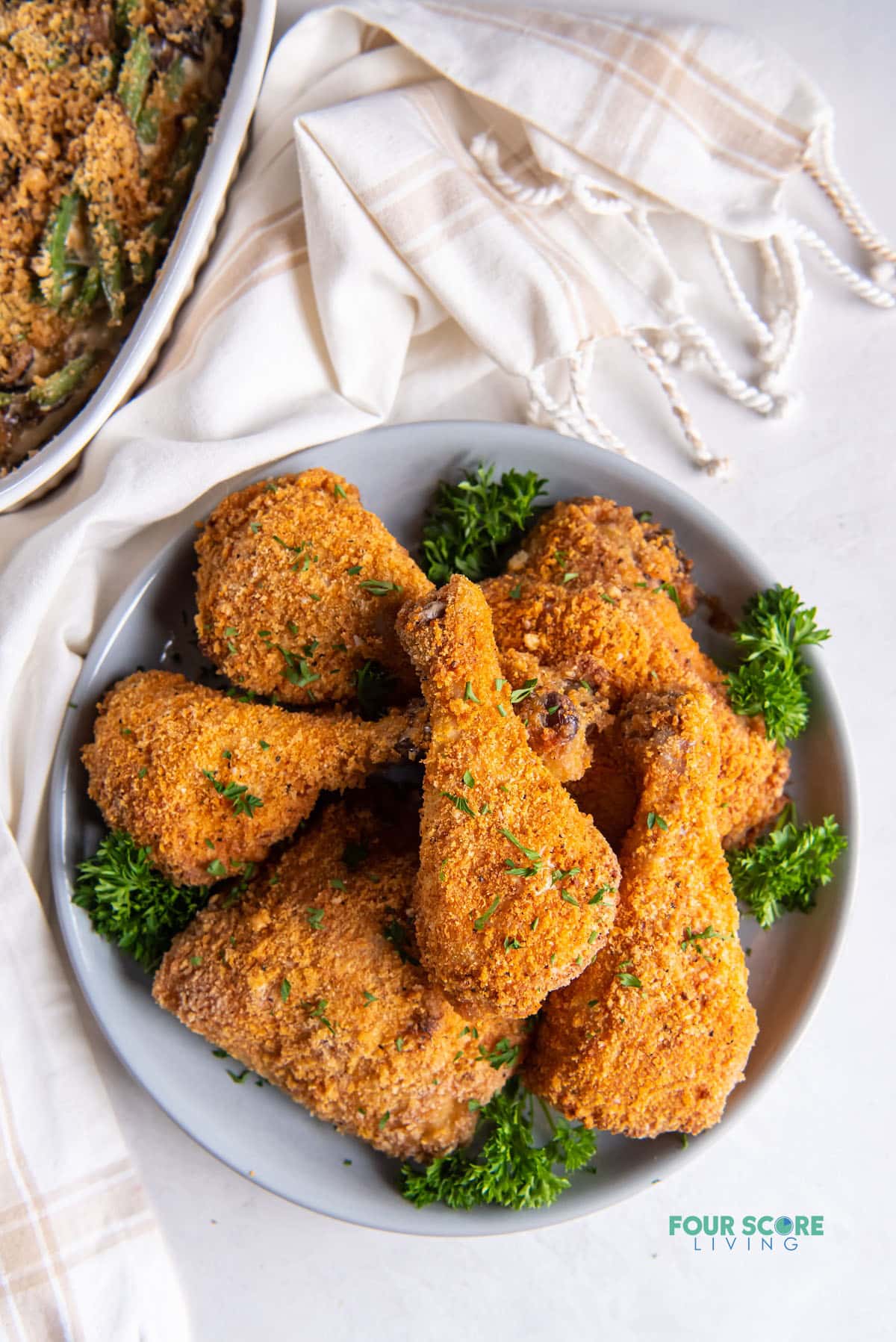 a large platter of keto fried chicken legs and thighs.