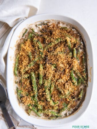 a white oval casserole dish filled with homemade keto green bean casserole, viewed from above