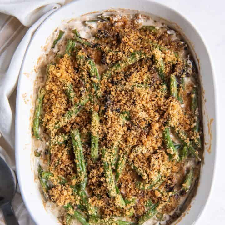 a white oval casserole dish filled with homemade keto green bean casserole, viewed from above
