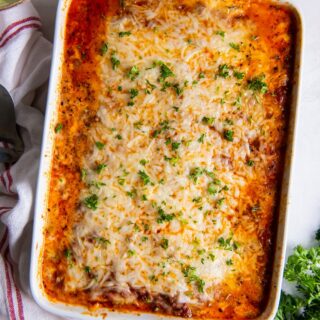 a white casserole dish of lasagna, viewed from above