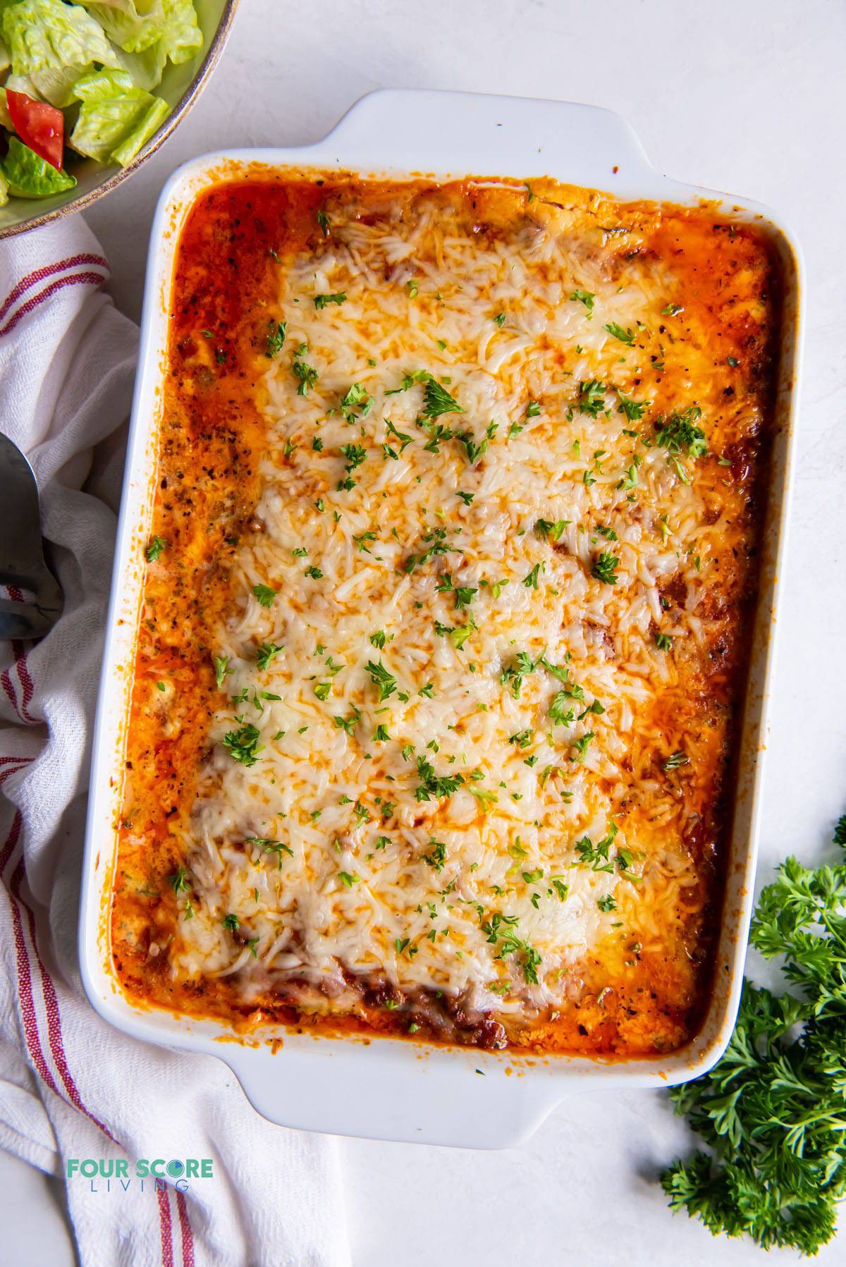 a white casserole dish of lasagna, viewed from above