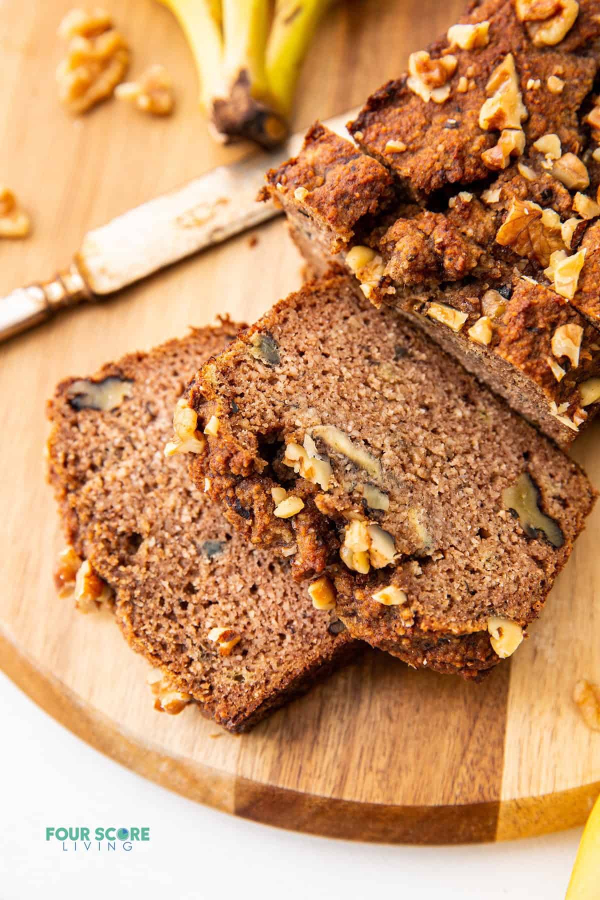 sliced almond flour banana bread on a wood cutting board