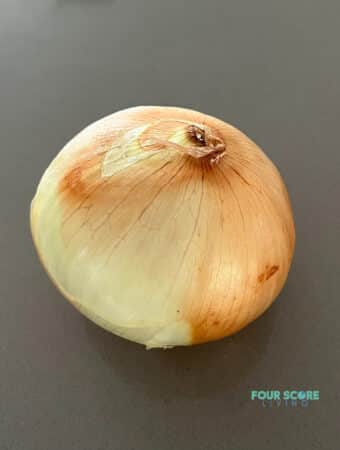 a yellow onion on a counter top