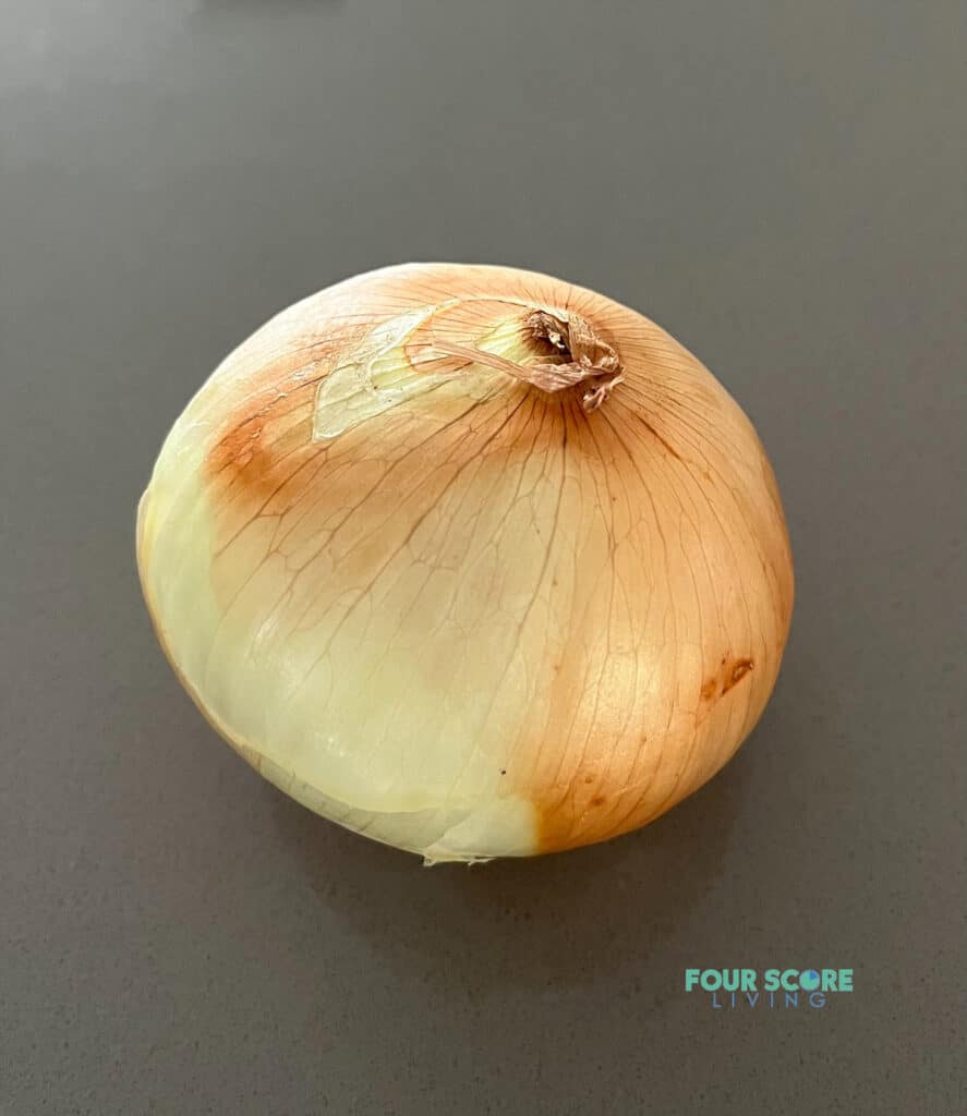a yellow onion on a counter top