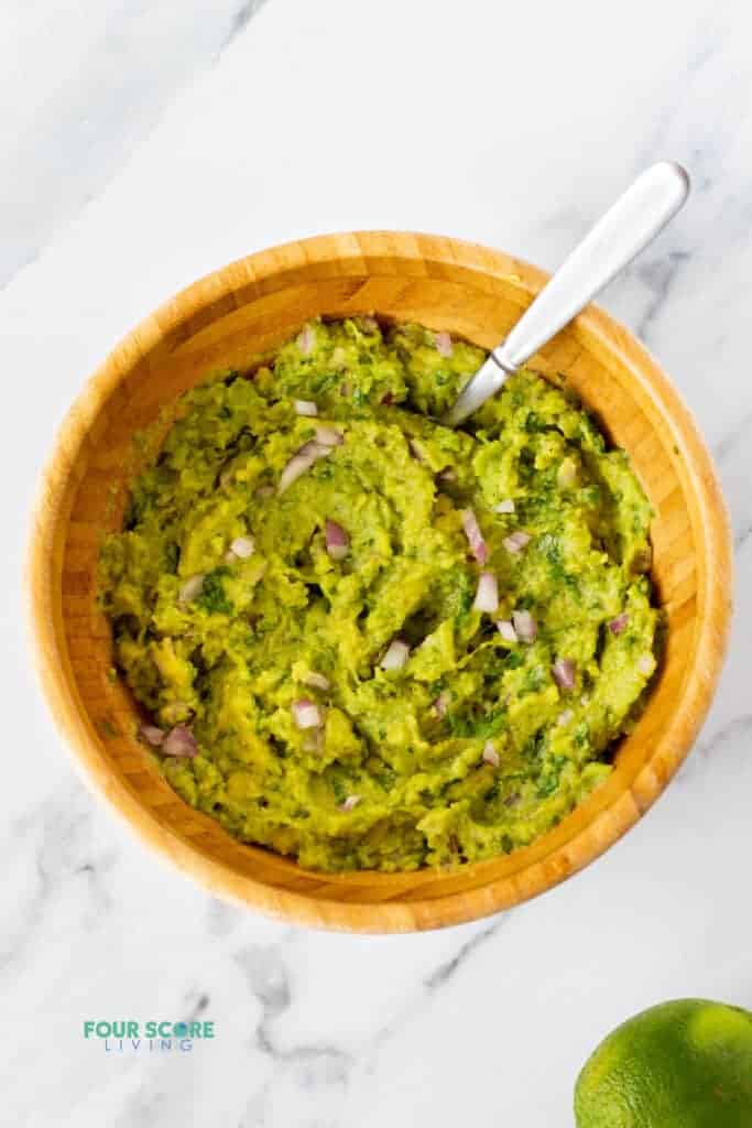 ingredients for 4 ingredient guacamole mixed together in a bowl