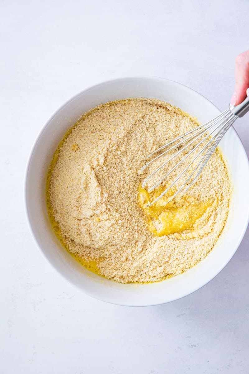 a bowl with the dry and wet ingredients for keto bread being mixed