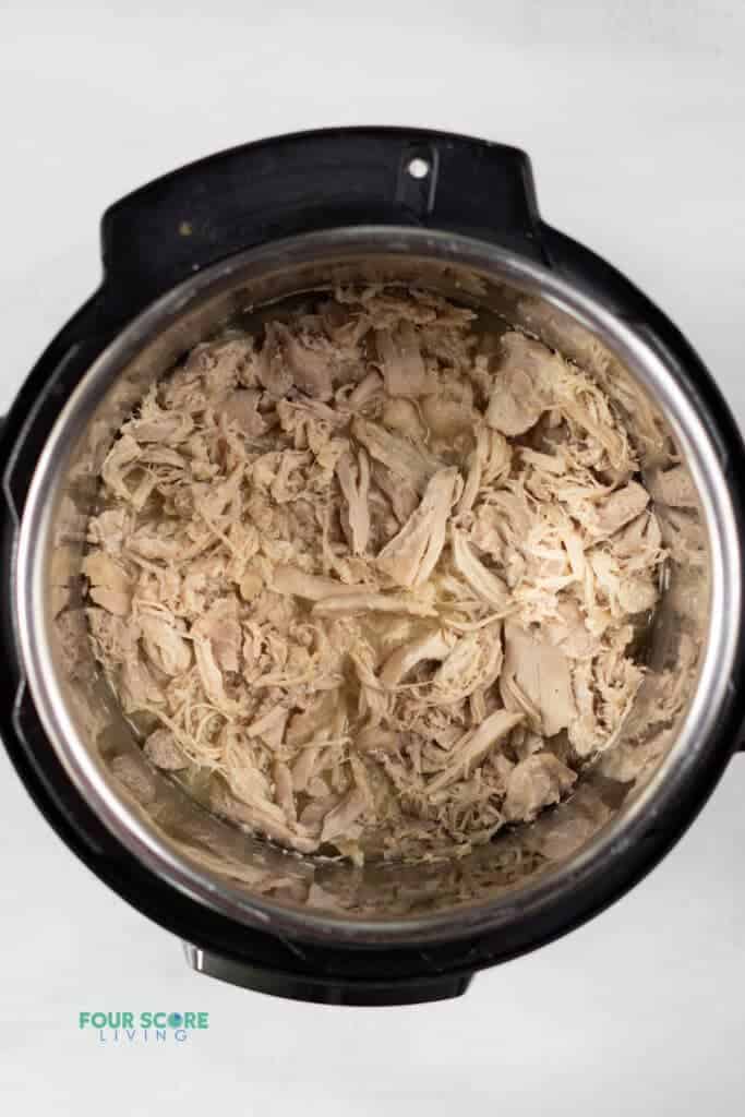 Top view photo of Instant Pot Shredded Chicken, fully cooked and shredded in the Instant Pot.