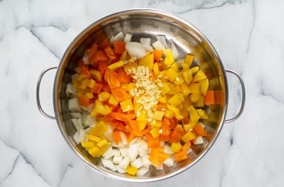 Topview photo of chopped vegetables in Keto Gumbo in a stockpot, ready to cook.
