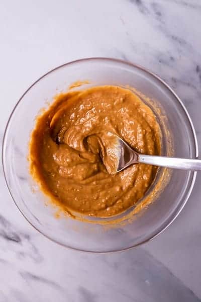 Top view photo of the peanut butter glaze for Peanut Butter Glazed Salmon mixed together in a clear bowl.