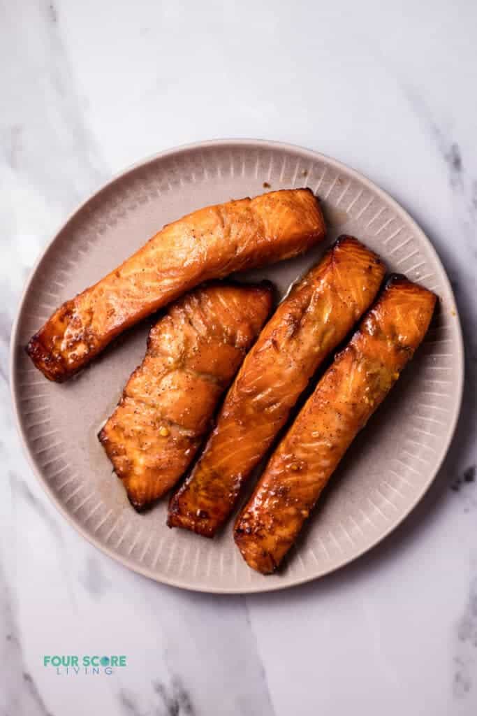 Top view photo of cooked salmon on a plate to make Salmon Rice Bowls.