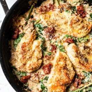 top view photo of tuscan chicken in a cast iron skillet