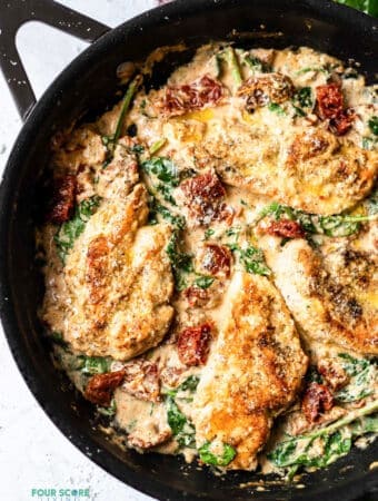 top view photo of tuscan chicken in a cast iron skillet