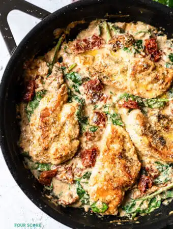 top view photo of tuscan chicken in a cast iron skillet