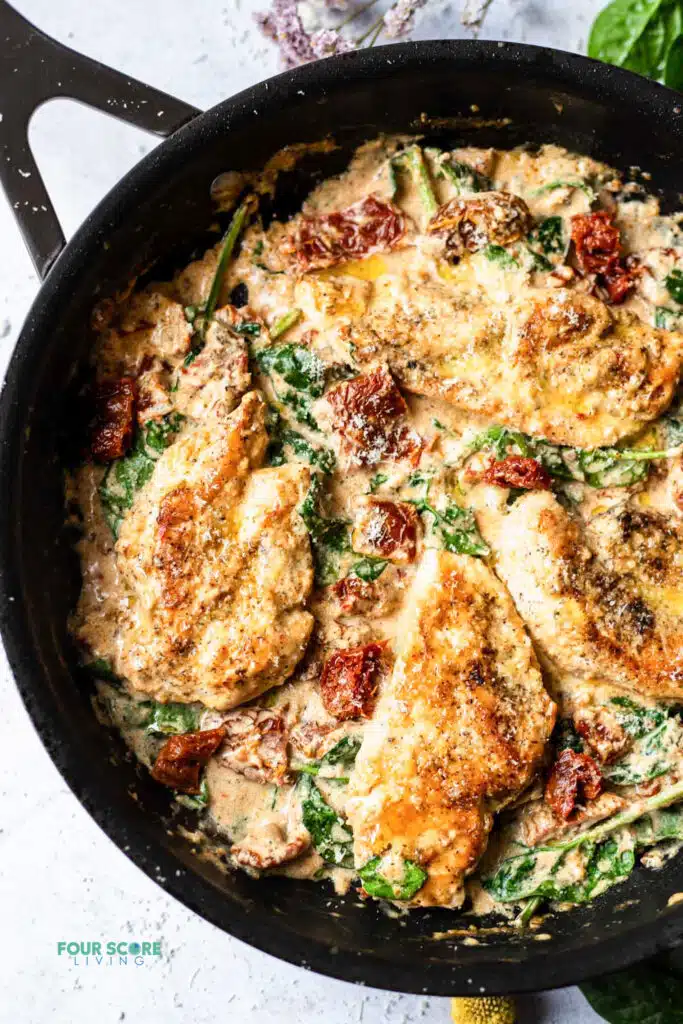 top view photo of tuscan chicken in a cast iron skillet