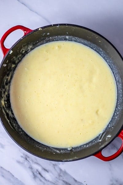 Top view photo of all the ingredients for 4 Ingredient Potato Soup blended together in a large stock pot with an emersion blender.