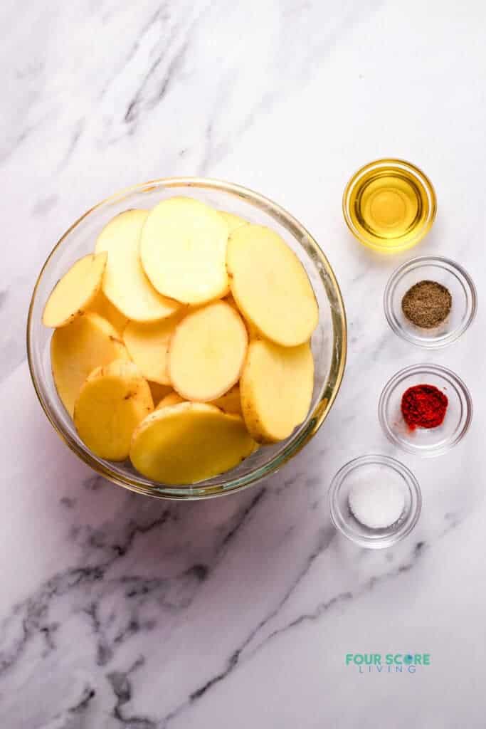 Top view photo of all the ingredients to make Cottage Fries in separate bowls.