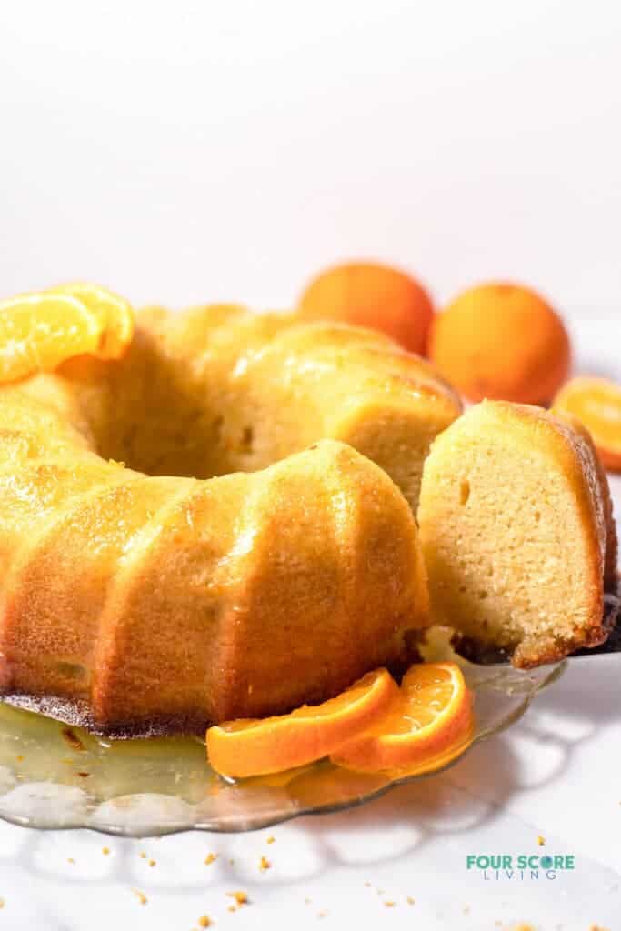 Photo of Italian Hangover Cake on a glass platter, with orange slices around the cake.