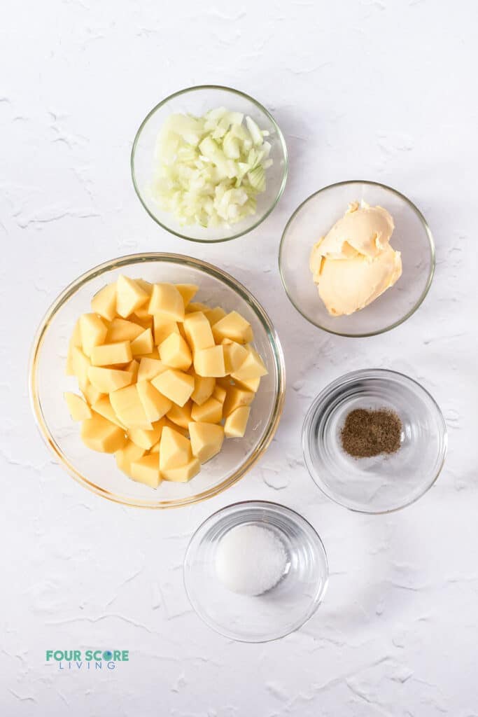 Top view photo of all the ingredients to make Stewed Potatoes, in separate bowls.