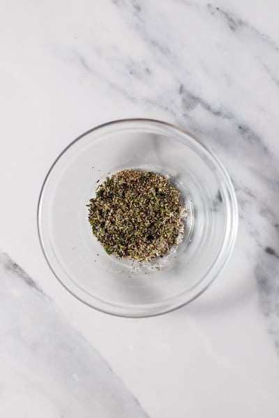 Top view photo of a glass bowl filled with spices for Pan Seared Pork Chops