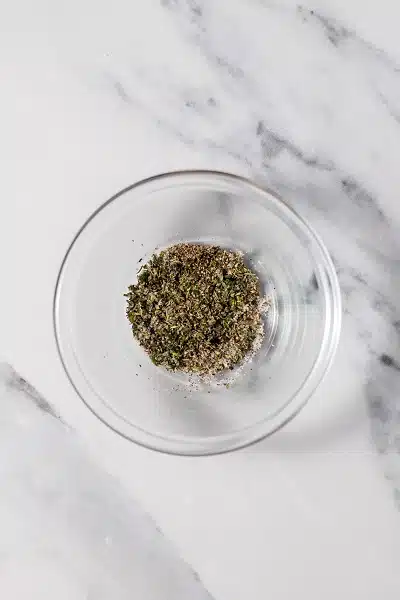 Top view photo of a glass bowl filled with spices for Pan Seared Pork Chops