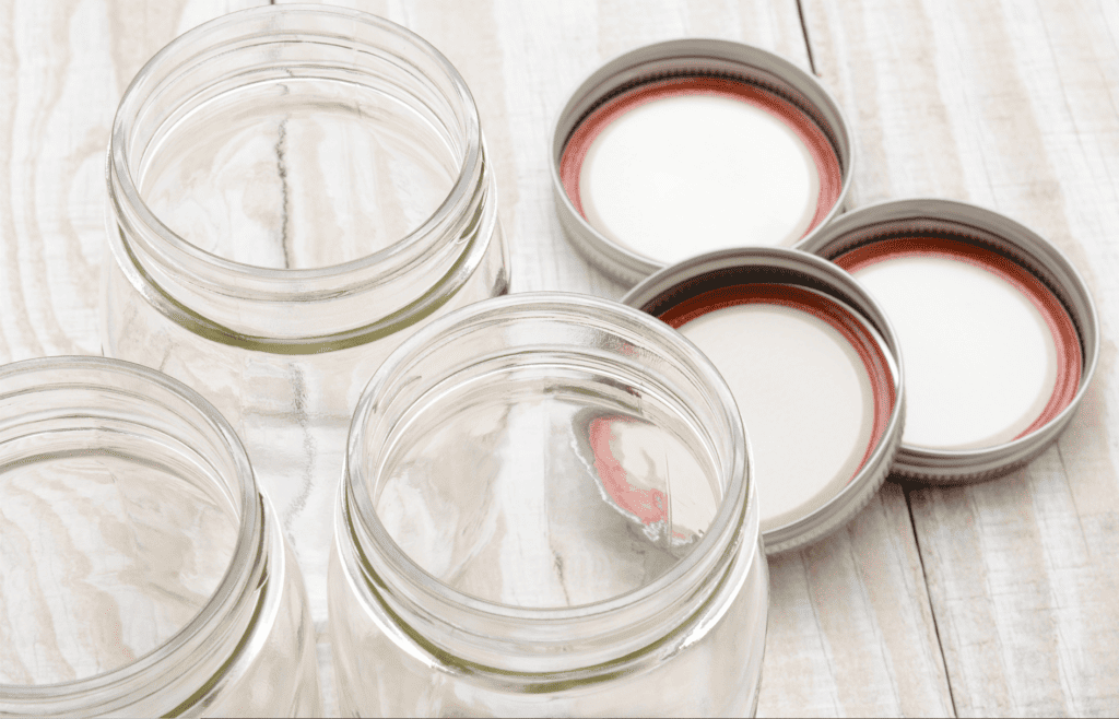 3 glass mason jars with their lids off and on the countertop.