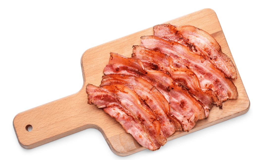 Light colored wood cutting board with approximately 8 slices of fried bacon placed on top, all on a white background.