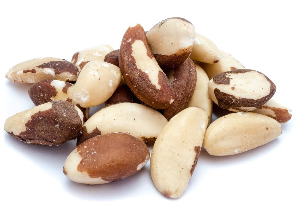 Pile of approximately 18 raw Brazil nuts on a white background.