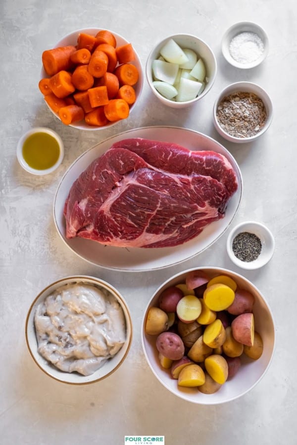 Ingredients in white dishes that are needed to make pot roast with onion soup mix with carrots and potatoes, including onion, salt, potatoes, roast, pepper, water, cream of mushroom soup.